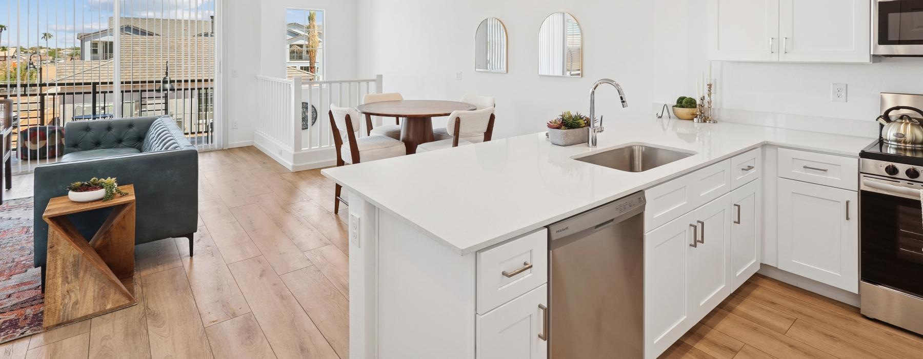 a kitchen bar with a dining table and chairs behind it