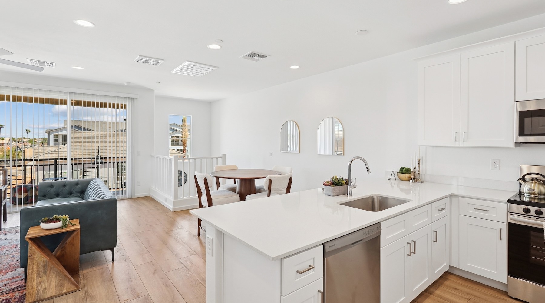 a kitchen and a living room with a couch and a dining table set